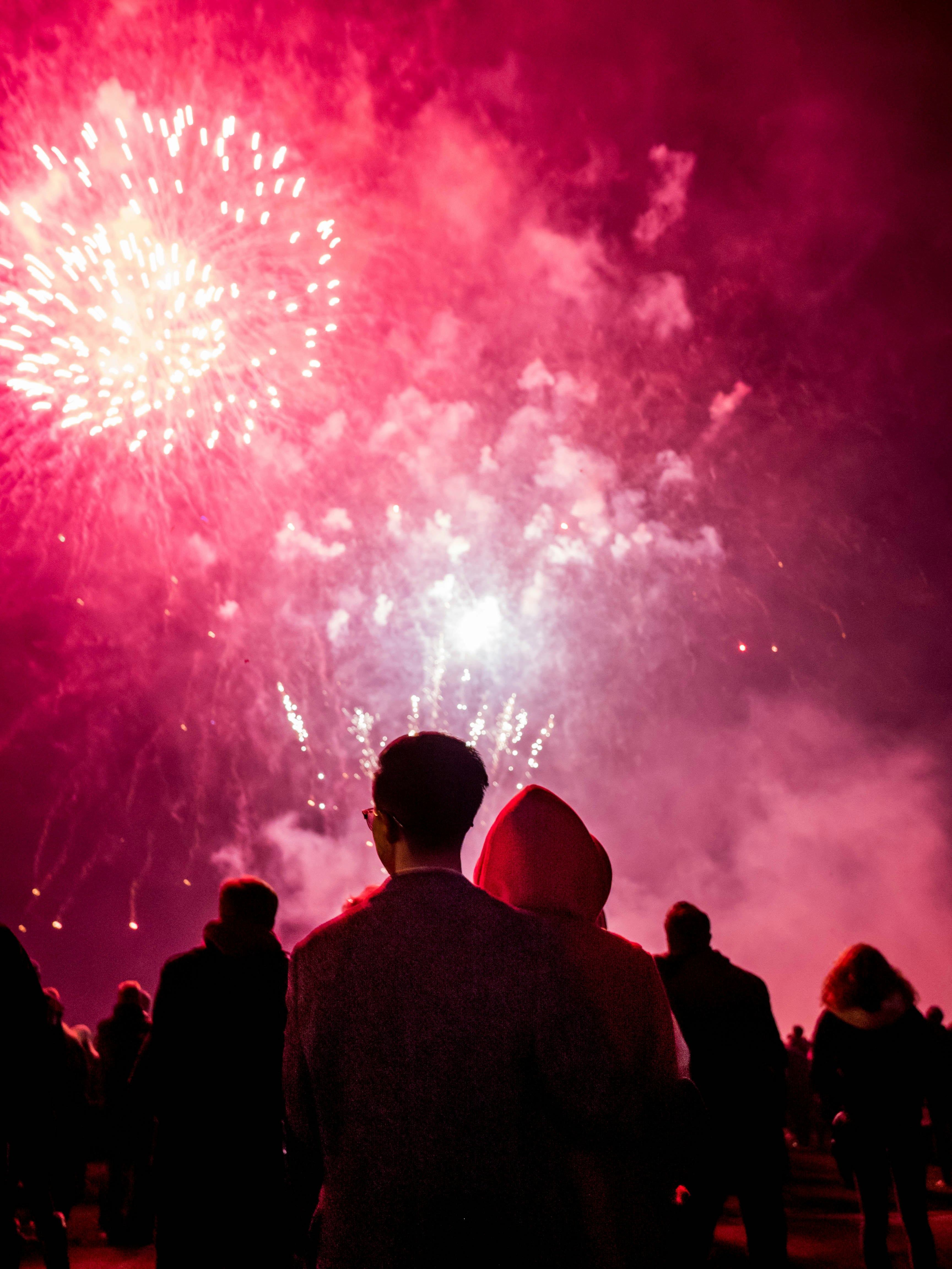 people watching fireworks during nighttime